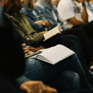 people sitting with notebooks on their laps